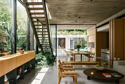 Casa de vidro iluminada com muito verde